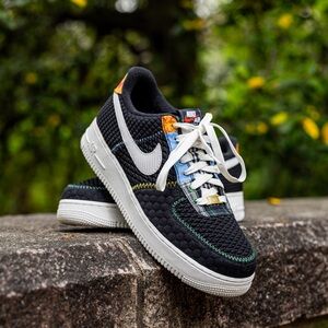 Black Quilted Nike Air Force 1 men’s shoes with orange and blue accents.